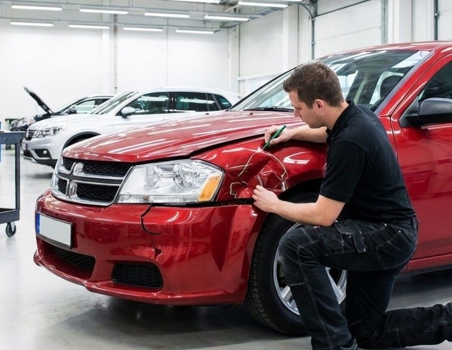 Certified Collision Repair estimator inspecting fender