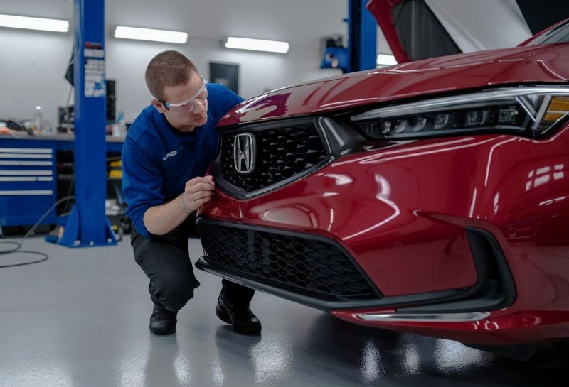 Bumper Repair tech inspecting