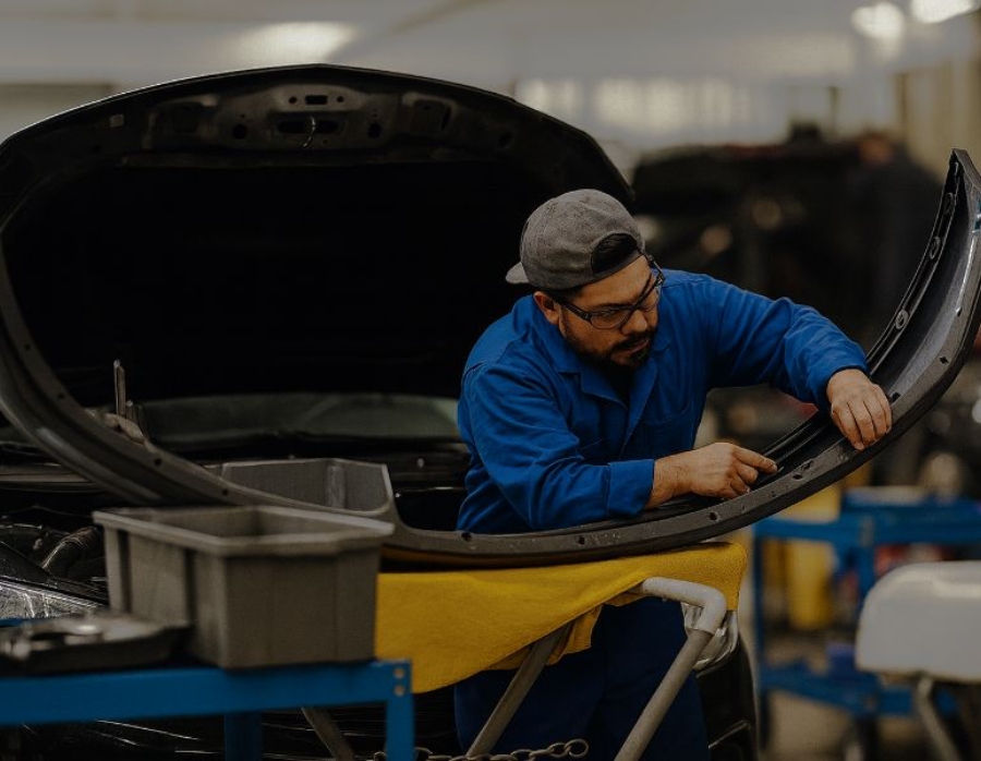 Bumper Repair tech prepping bumper