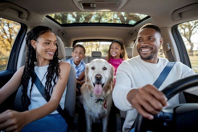 family-in-car-smiling-leaving-auto-body-shop-in-Newport-News-VA