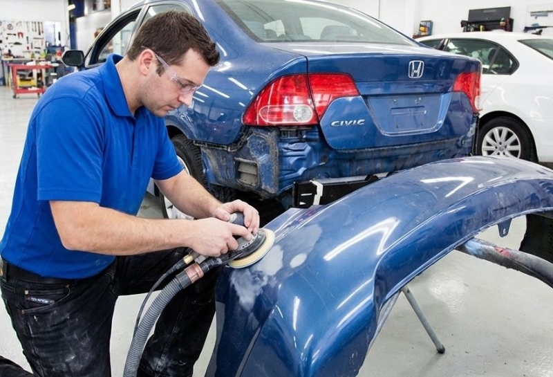 Certified Collision Repair tech sanding bumper Certified Collision Repair tech sanding bumper